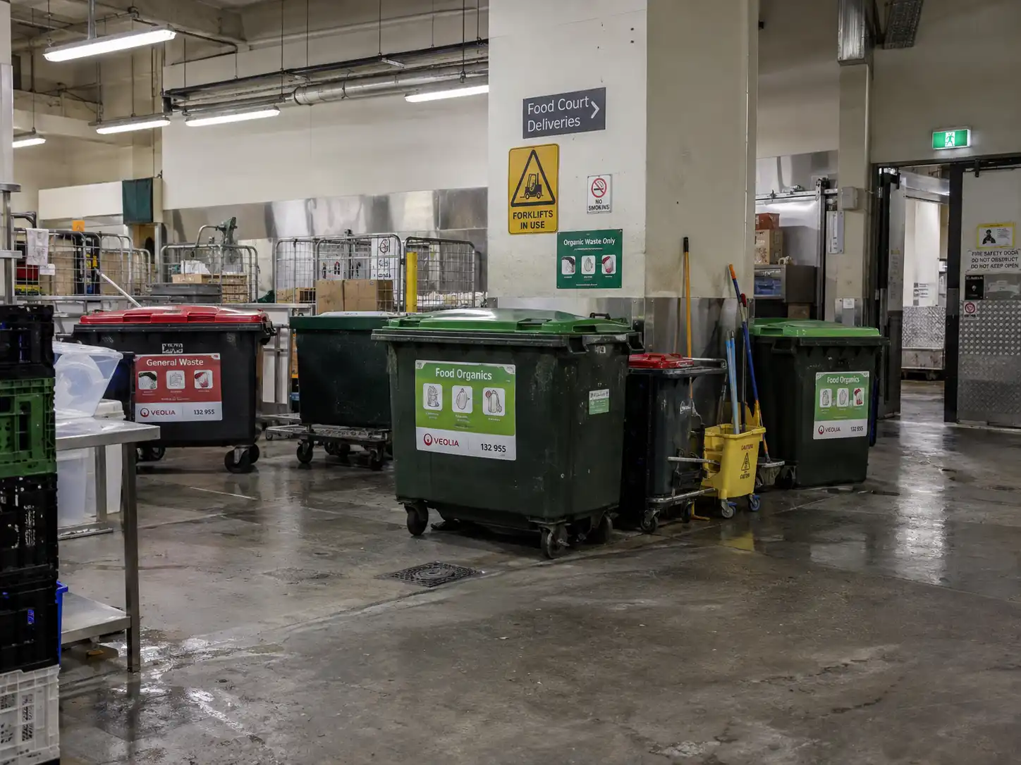 Food organics and general waste wheelie bins in a shopping centre back-of-house waste area near the food court
